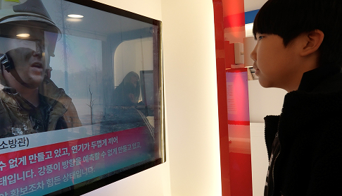 현장의 소방관을 담은 뉴스를 보며 디지털 교육을 받는 어린이의 모습